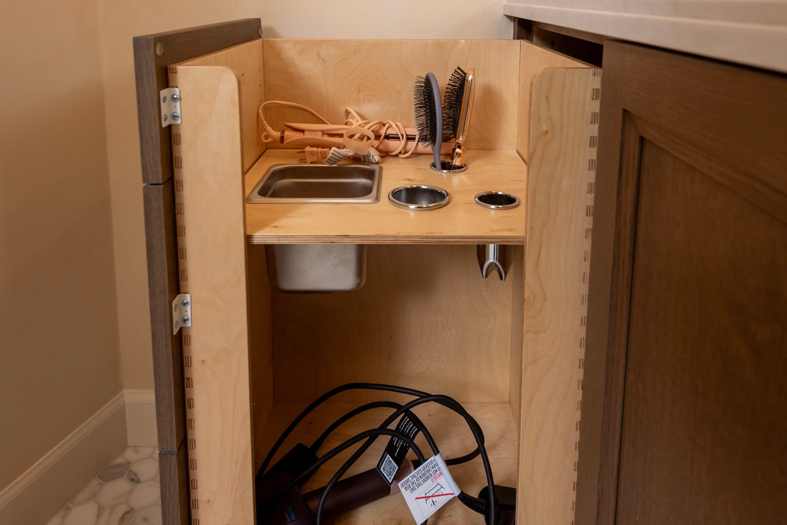 Hair-tool pull-out with built-in outlet