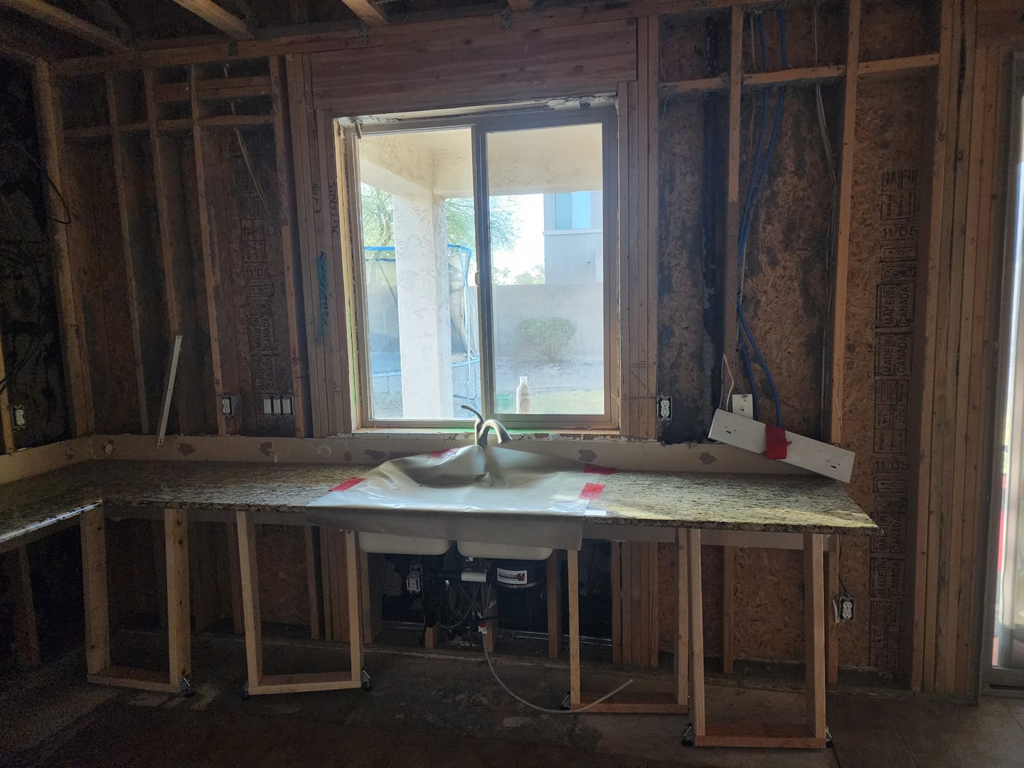 kitchen, Down to the studs: The sink wall stripped to bare framing.